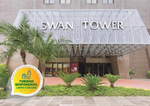 a building with a sign on the front of it at Swan Porto Alegre in Porto Alegre