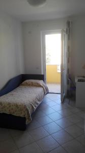 a bedroom with a bed and a door to a room at B&B Gigi’ in Marina di Massa