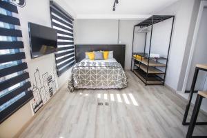 a bedroom with a bed and a television in it at Studio Temático Bem Espaçoso - ALL1503 in Curitiba