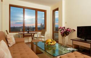 a living room with a couch and a glass table at Stanny Court ApartHotel in Nesebar