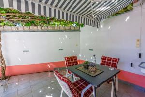 a dining room with a table and red chairs at Apartments Marijana in Crikvenica