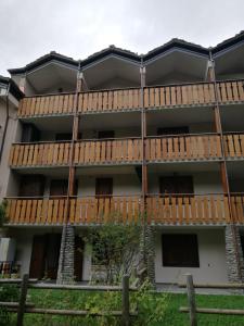 an apartment building with wooden balconies on it at Le Sapin 2 in Cogne +11 photos