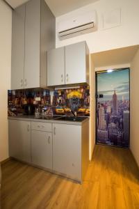 a kitchen with white cabinets and a view of a city at Metropolis Apartments in Zagreb