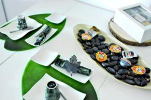 a table with a tray ofocolates and a plate of food at Appartement de L'Espiguette in Le Grau-du-Roi