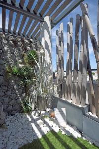 a fence with a bunch of skis on it at Appartement de L'Espiguette in Le Grau-du-Roi
