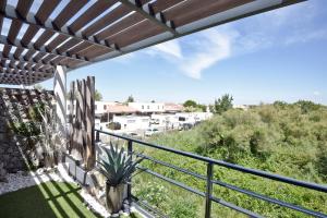 a view from the balcony of a house with a cactus at Appartement de L'Espiguette in Le Grau-du-Roi