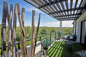 a view from the balcony of a house with a pergola at Appartement de L'Espiguette in Le Grau-du-Roi