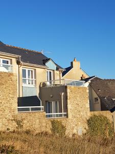 a house with a stone wall in front of it at Le Cézembre - vue 180 baie St Malo in Saint Malo