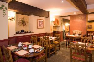 a dining room with wooden tables and chairs at George & Pilgrims Hotel in Glastonbury +29 photos