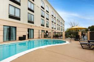 a swimming pool in front of a building at Holiday Inn Savannah South - I-95 Gateway, an IHG Hotel in Savannah