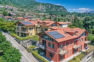 a group of houses with a mountain in the background at Apartment Best - Tremezzina in Tremezzo