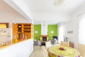a kitchen and dining room with a table in a room at Gaia Residence in Hersonissos