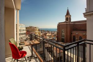 a balcony with a table and chairs and a church at West Palace in Istanbul