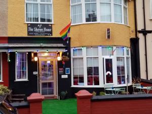 a building with a rainbow flag on the front of it at A&P at The Sheron House in Blackpool