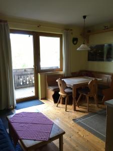 a living room with a table and two chairs at Eisenhut Suite 3 in Turracher Hohe +8 photos
