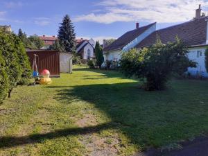 a yard with a house and a fire hydrant at HEMNES Apartman in Kaposvár