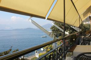 a balcony with a view of the ocean at Foresteria Hostaria Del Golfo cod struttura C00025 in Laveno-Mombello