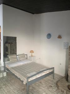 a bedroom with a large bed in a white wall at Apartments Peace&Love in Baška