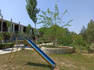 a playground with a blue slide in a park at Kavalona Park in Vlorë +35 photos