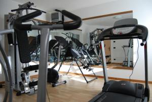 a gym with a bunch of exercise bikes at Residence Ciasa Alpe in Vigo di Fassa