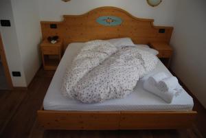 Una cama con dos almohadas encima. en Residence Ciasa Alpe, en Vigo di Fassa