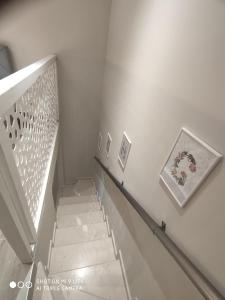 a staircase in a building with a picture on the wall at Kamares suites in Nea Kallikrateia