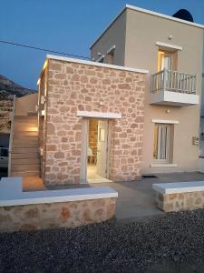 a house with a stone facade with a staircase at en lefko in Lefkos Karpathou
