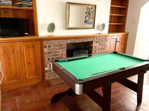 A pool table at Glan y Mor House