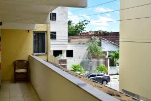 a balcony of a building with a car on a street at Pousada do Turista in Fortaleza