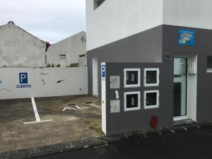a facade of a building with a parking lot at Cantinho do Sonho in Maia