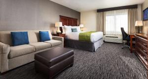 a hotel room with a bed and a couch at Best Western Plus Landmark Inn in Park City