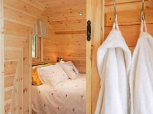 a bedroom with a bed in a wooden cabin at The Rhiw in Newtown
