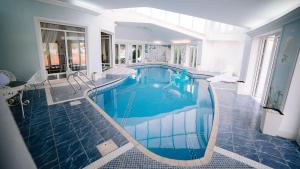 a swimming pool in the middle of a house at Fruška Gora Klub Krstašice in Irig