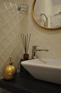 a bathroom with a white sink and a mirror at Barra Apartament Design in Gafanha da Nazaré +25 photos