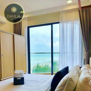 a bedroom with a bed with a view of the ocean at Spectacular High Floor Sea View Residence in Kuantan +14 photos