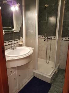 a bathroom with a sink and a shower at Casa do Mar in Peniche