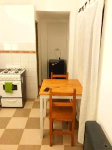 a kitchen with a table and a stove and a table and chairs at MG Suites in Monte Grande