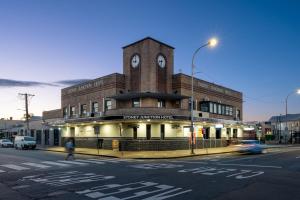 Hamilton的住宿－Sydney Junction Hotel，一座建筑的顶部有一个钟楼