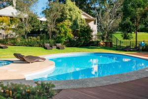 a pool with a bird sitting on the edge of a yard at McMillans Villa 18 Metung in Metung