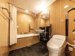 a bathroom with a toilet a sink and a shower at APA Hotel Roppongi SIX in Tokyo