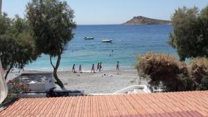 a group of people playing in the water on a beach at Argo Studios in Myrties