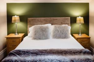 a bedroom with a large bed with two night stands at The Rectory Rooms, Studio 4 in Skipton