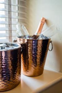 a bottle of champagne in a copper bucket on a counter at The Rectory Rooms, Studio 2 in Threshfield