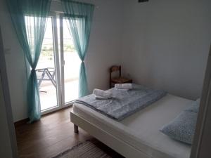 Postel nebo postele na pokoji v ubytování Apartmani Sol Vlašići