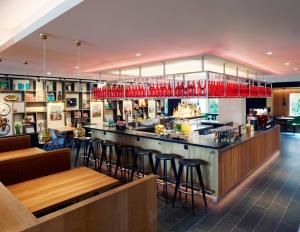 a restaurant with tables and chairs in it at citizenM Amstel Amsterdam in Amsterdam