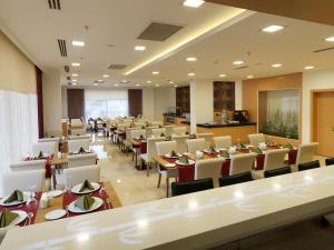 a large dining room with tables and chairs at Inci Class Hotel in Denizli