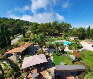 an aerial view of a resort with a pool and a garden at Hôtel Eze Hermitage B&B in Éze