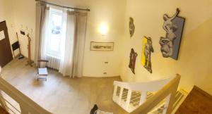 una sala de estar con una escalera y algunas estatuas en la pared en A Casa Di Olga, en Florencia
