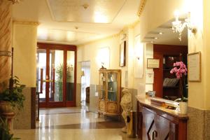 a lobby of a building with a counter and a hallway at Hotel Genio in Rome