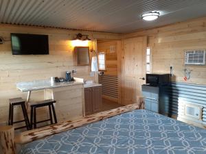 a kitchen with a stove and a sink in a room at Glacier Acres Guest Ranch in Columbia Falls